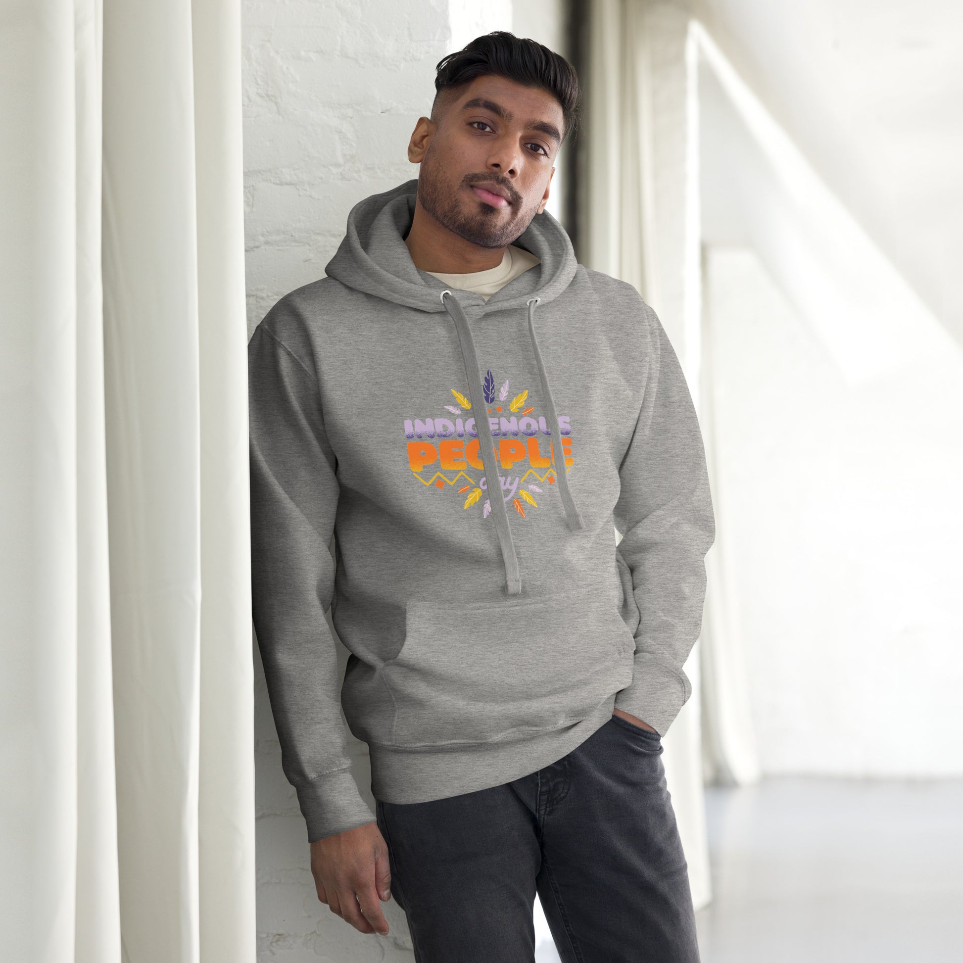 Male model leaning against a wall in a gray Hoodie