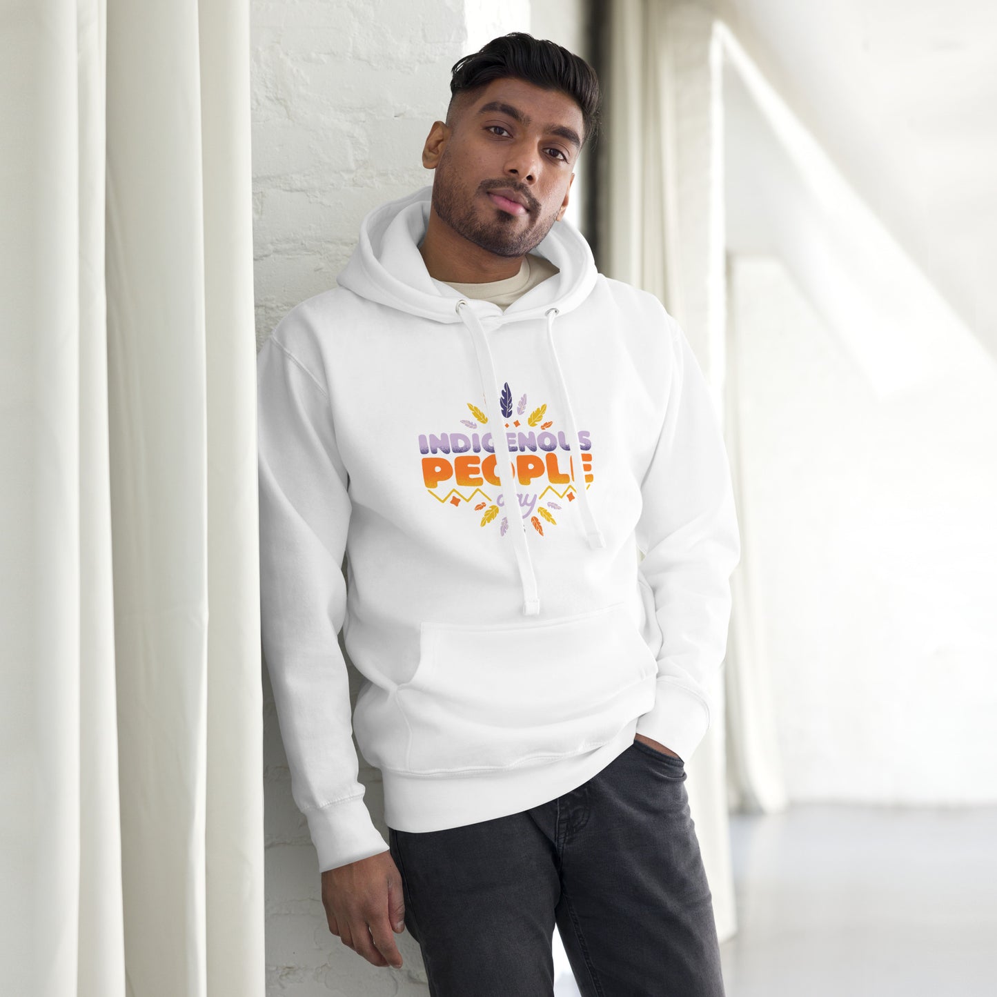 Male model leaning against a wall in a white Hoodie